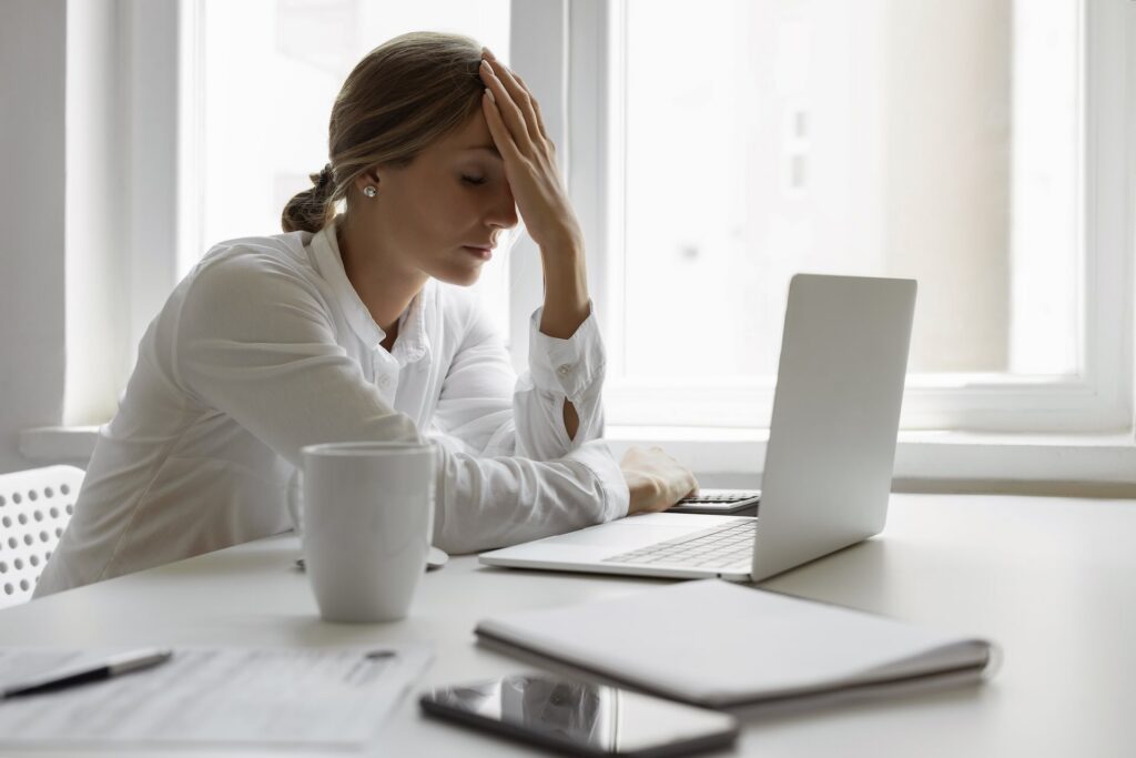 Borrower working through federal student loan paperwork on a laptop at home.